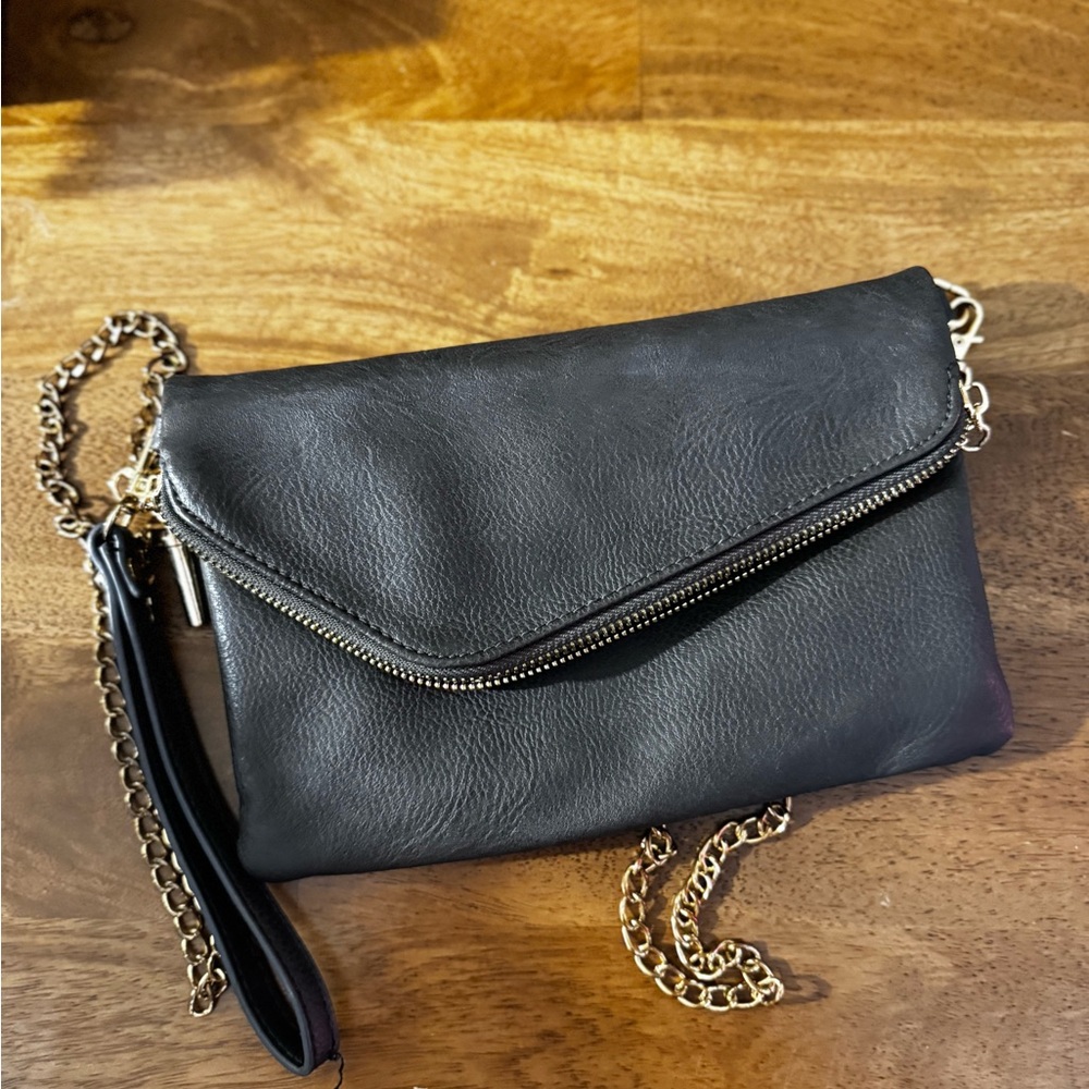 FashionPuzzle faux leather clutch bag with chain shoulder strap. Striped lining
